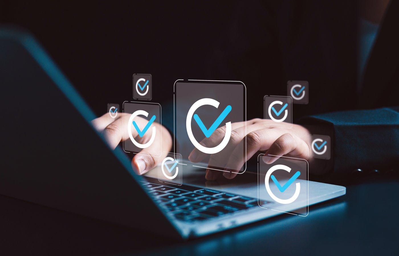 hands typing on laptop. Floating circles with checkmarks are above the keyboard in the air.