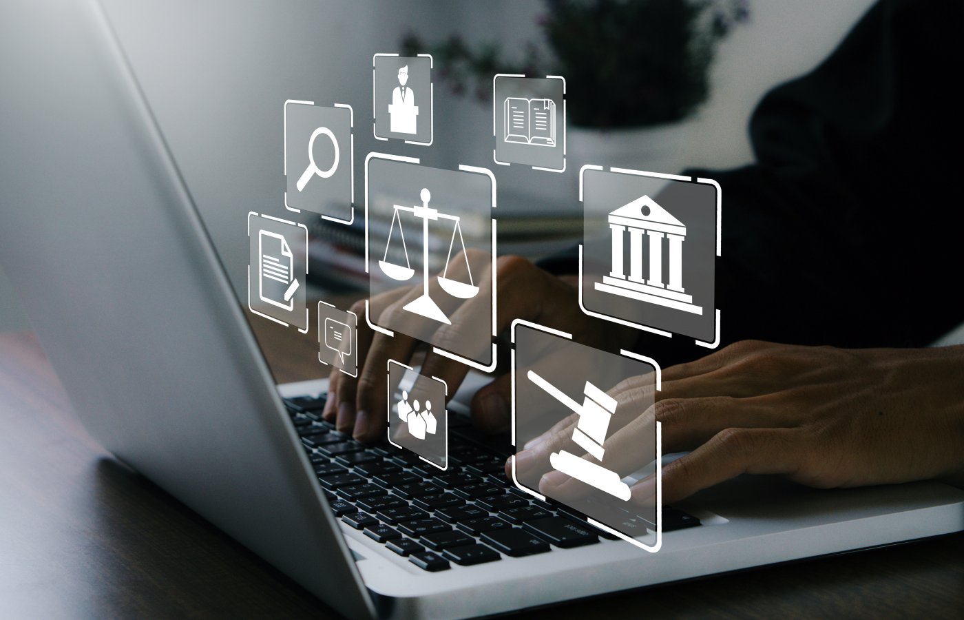 law-related icons such as a gavel, scale, person are floating in the air above a computer laptop with hands typing