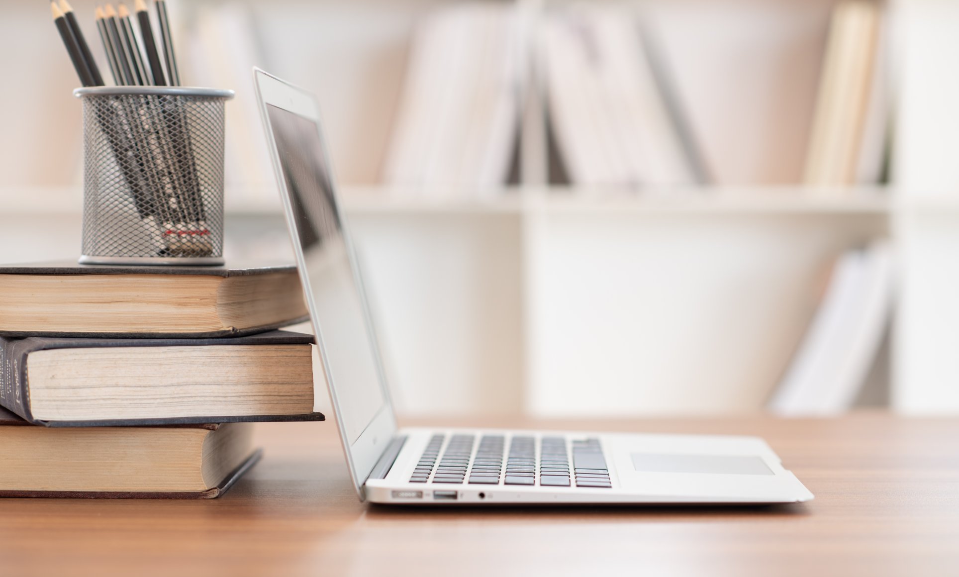 stacked books and computer