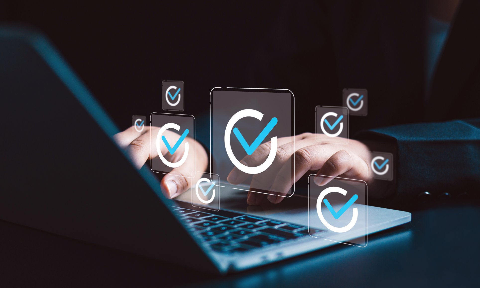 hands typing on laptop. Floating circles with checkmarks are above the keyboard in the air.