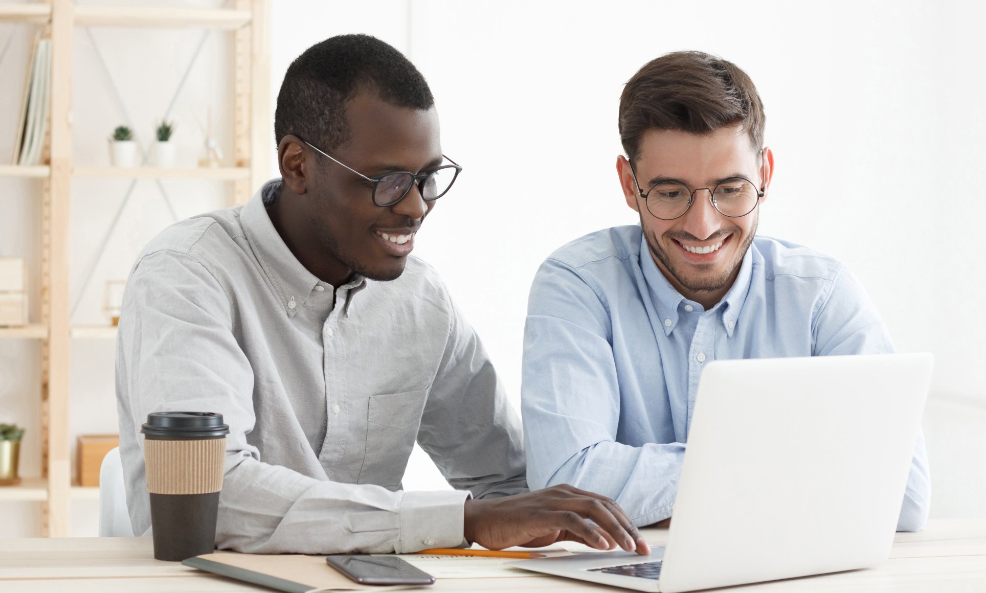 two men looking at computer