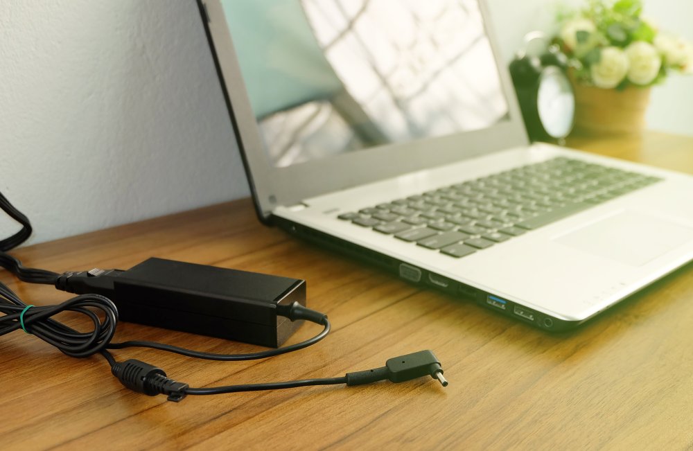 Laptop and power cable on a table