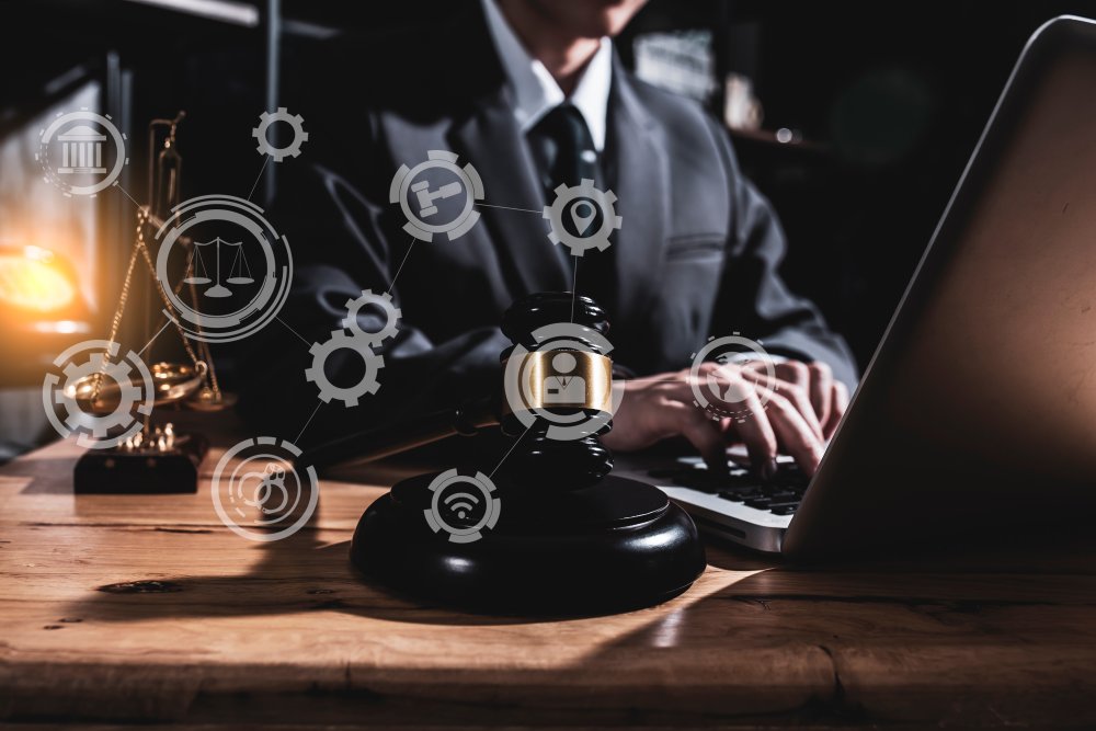 person at laptop with holographic law icons